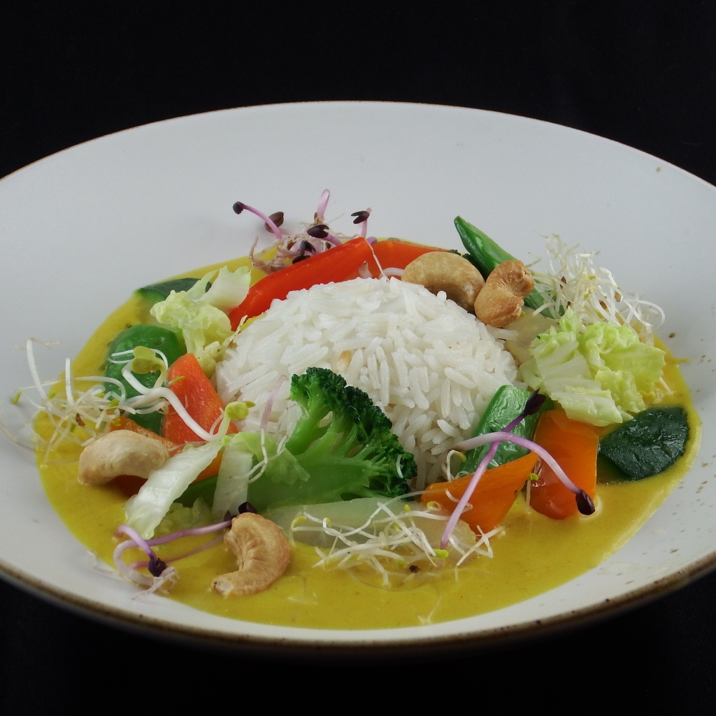 Вареный рис с овощами в большой белой тарелке