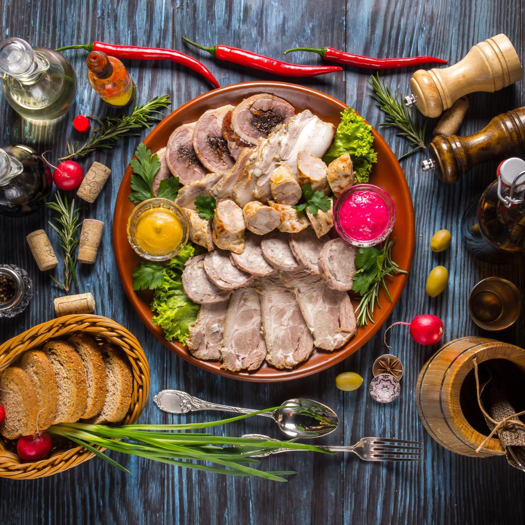 Appetizing cold cuts on the table with spices and bread