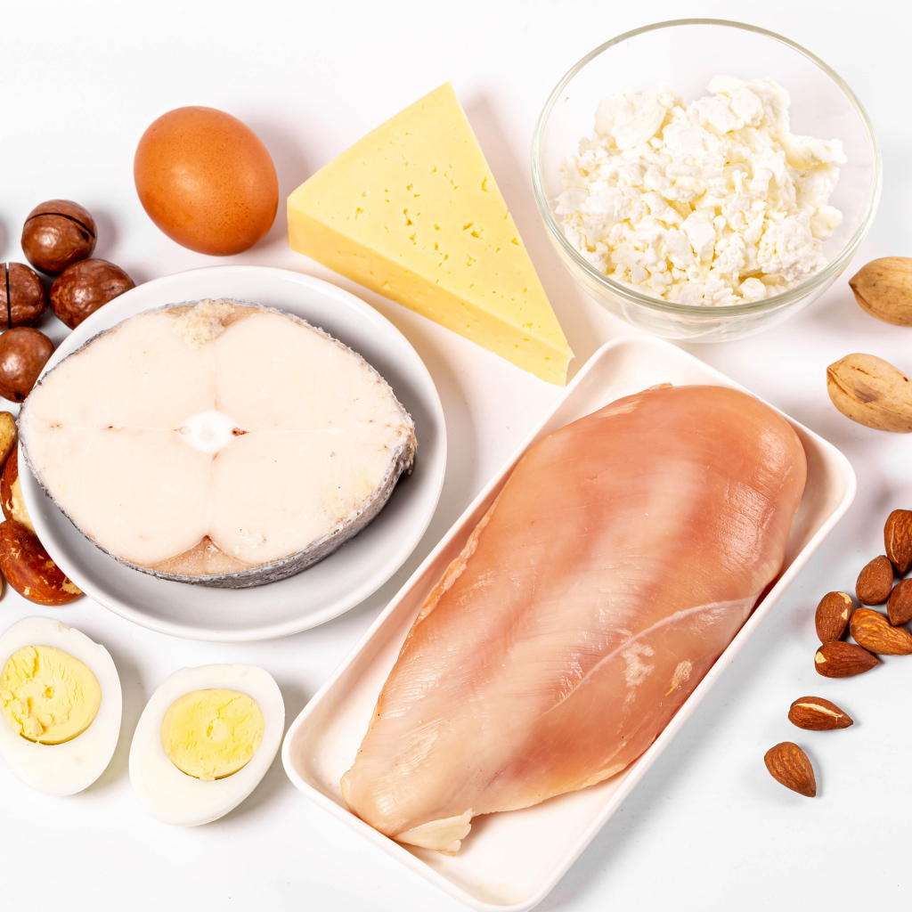 Fresh chicken, fish, nuts, cottage cheese and eggs on the table