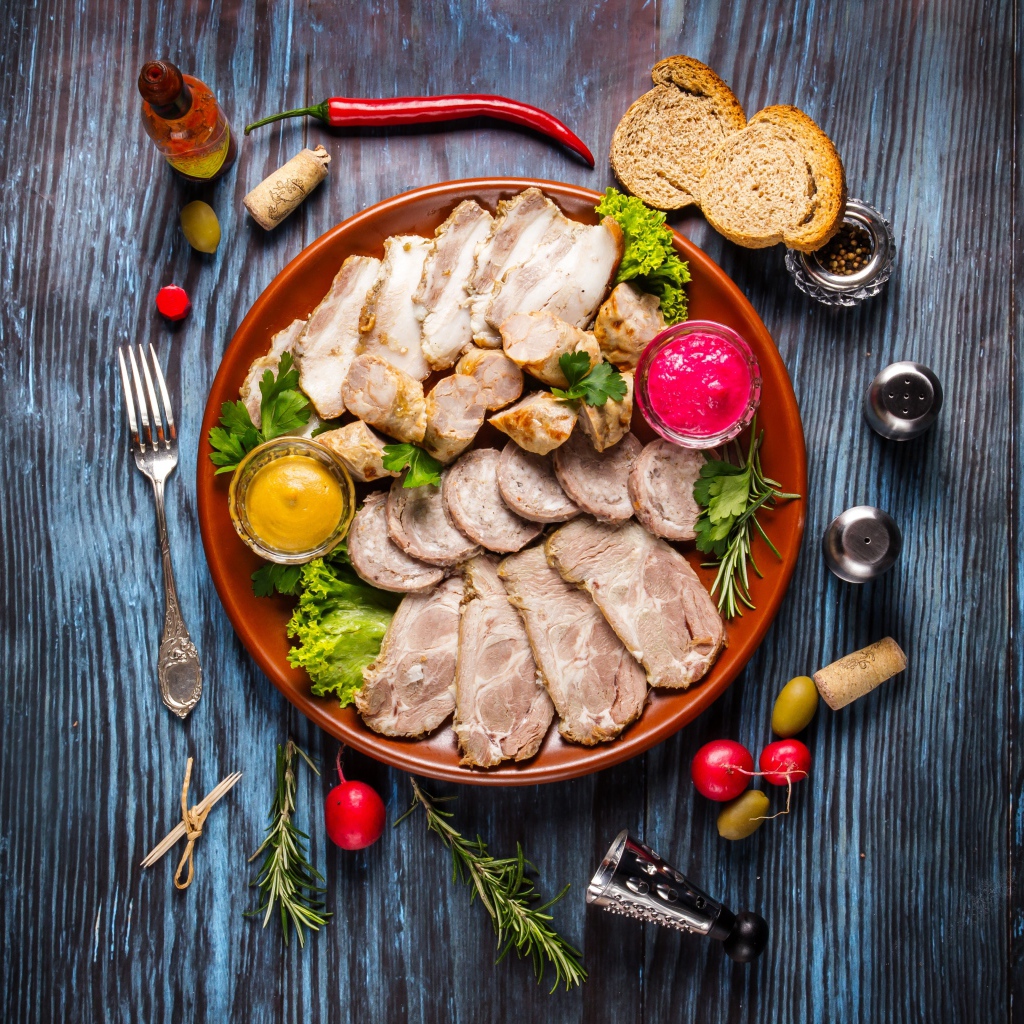 Meat platter in a plate with sauce and herbs