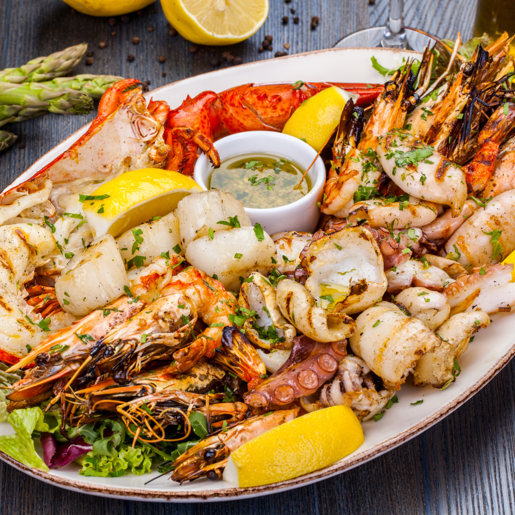 Baked seafood on a plate with lemon