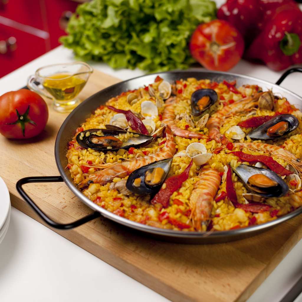 Pilaf with seafood on a table with vegetables