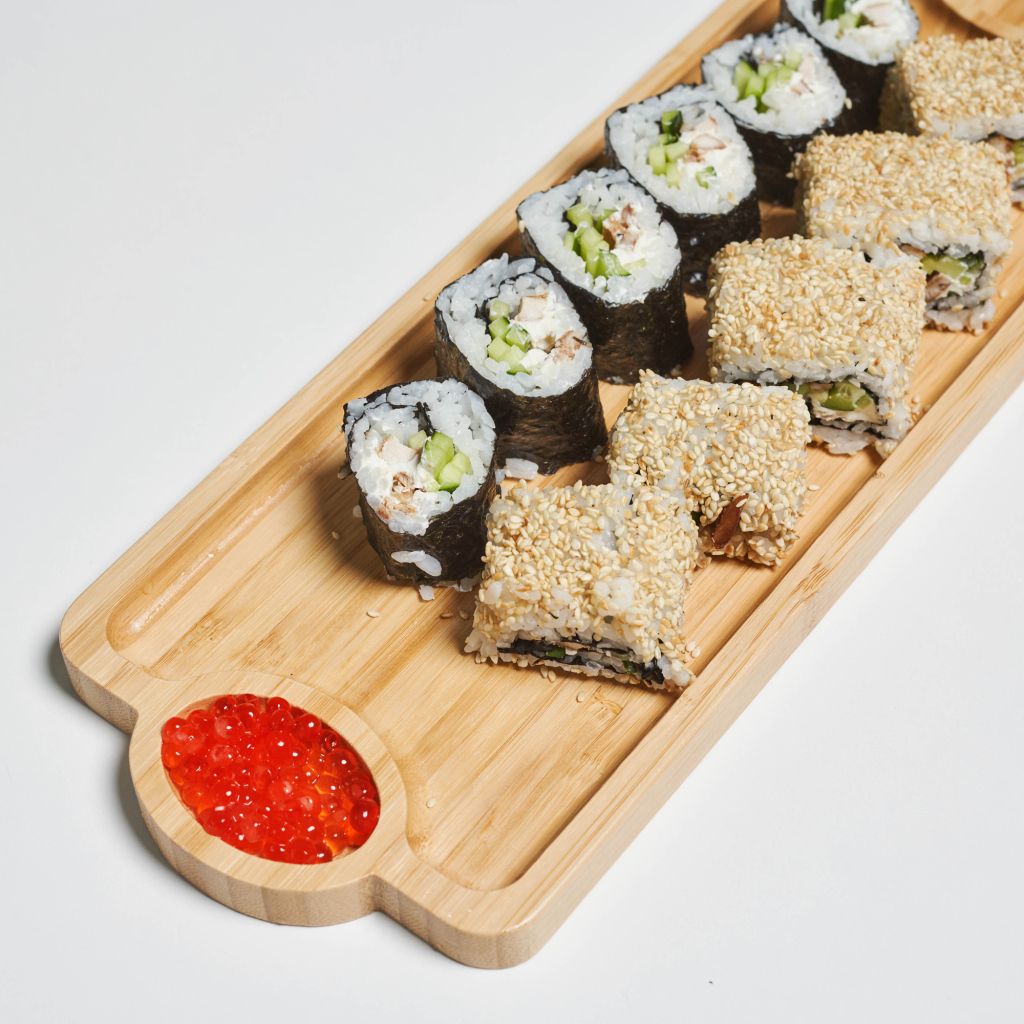 Sushi with red caviar on a cutting board