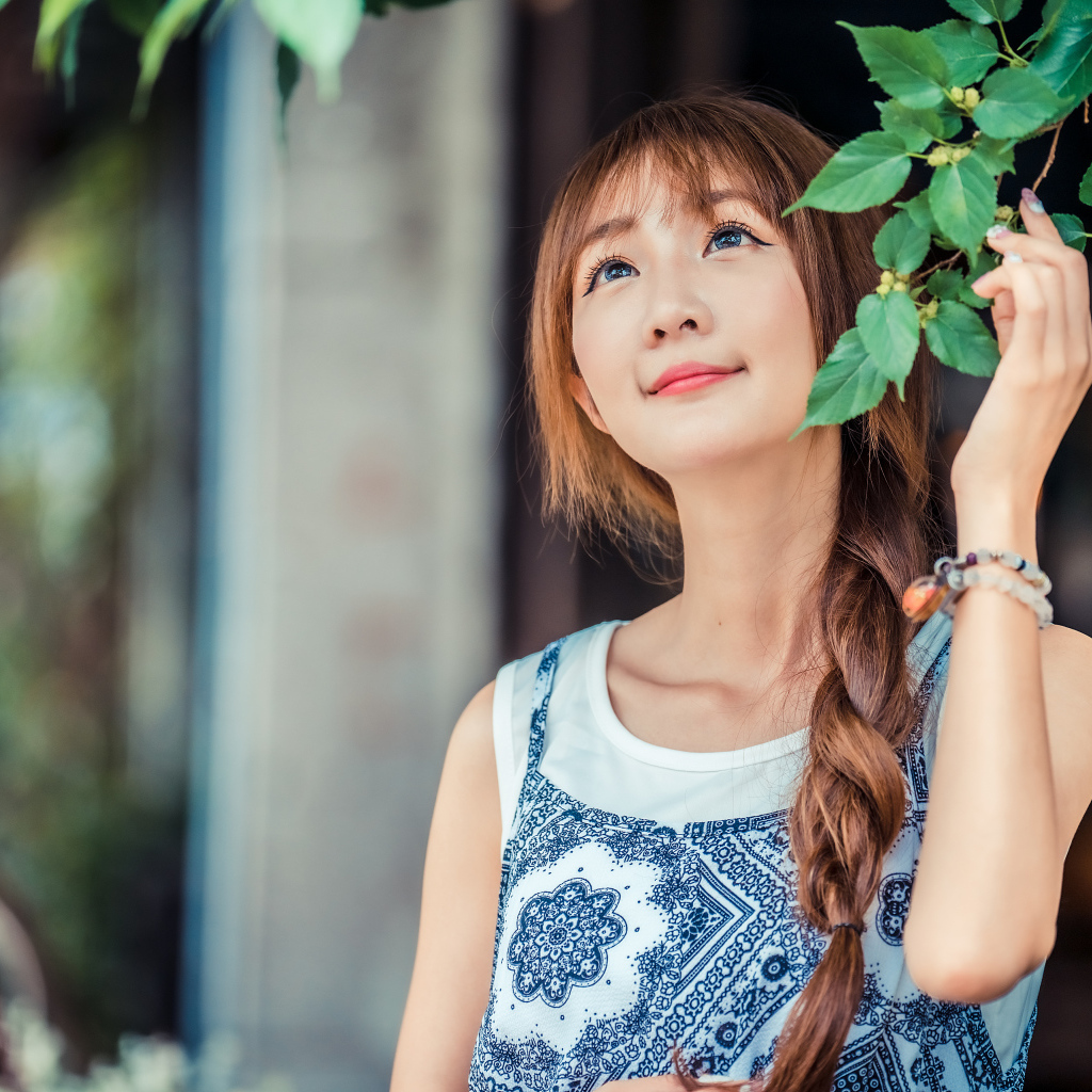 Милая девушка азиатка с косой на голове