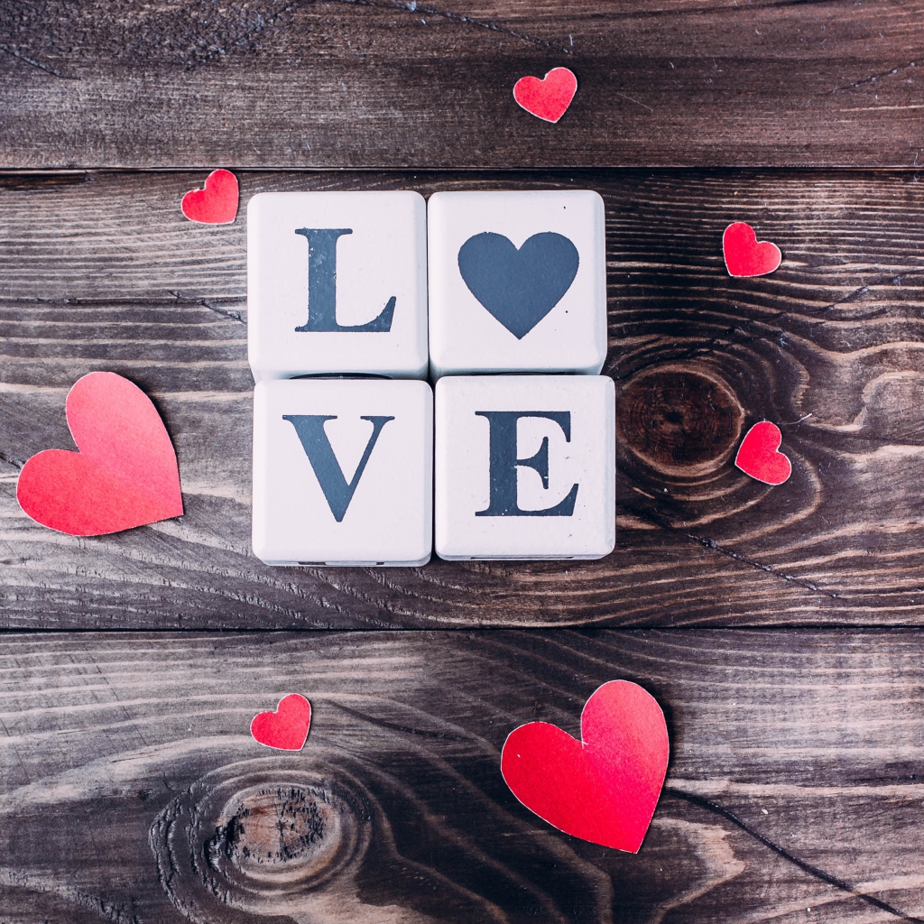 Кубики  с надписью любовь с сердечками на деревянном столе