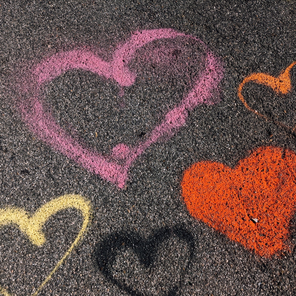 Сердечки разноцветным мелом на асфальте