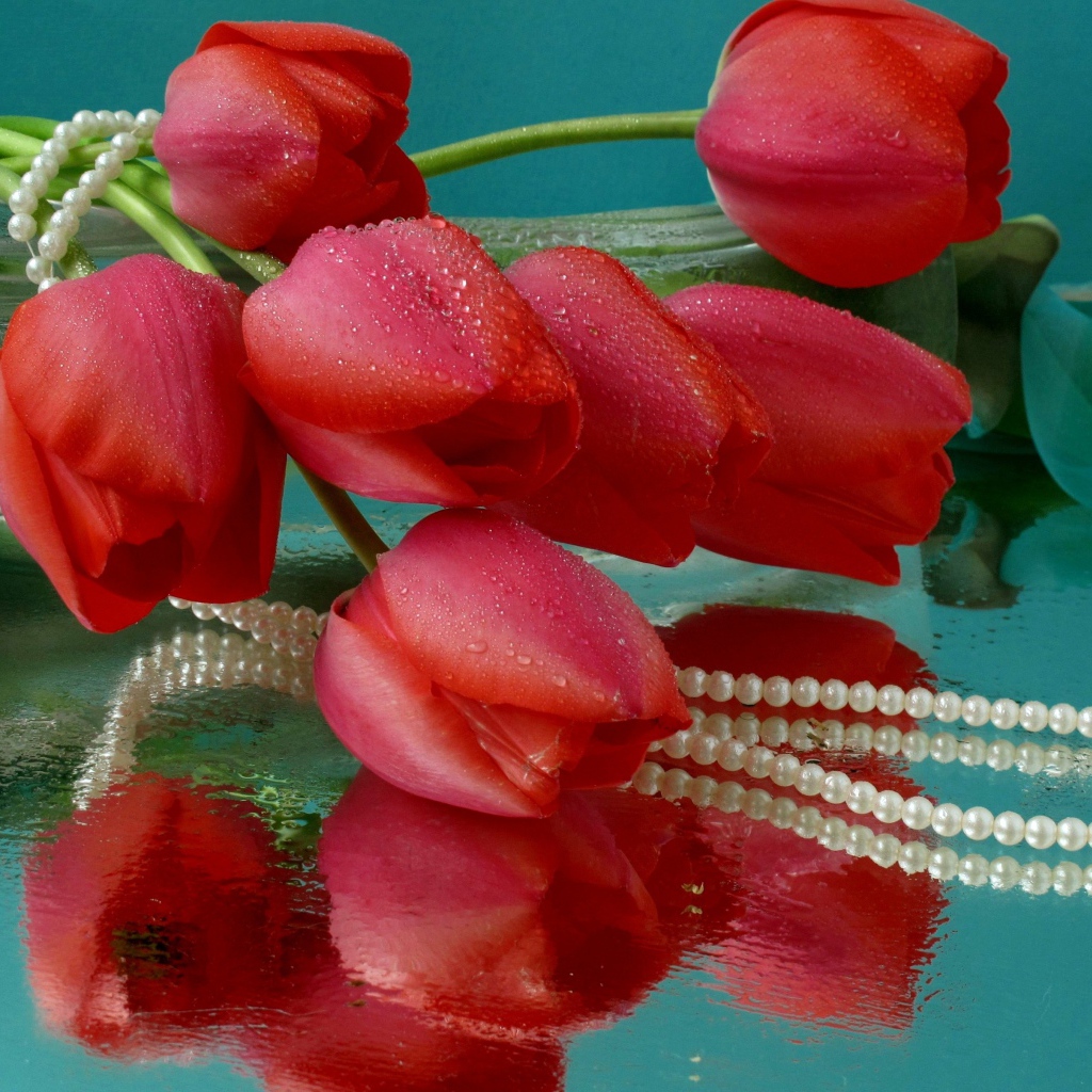 Bouquet of red tulips and pearl beads