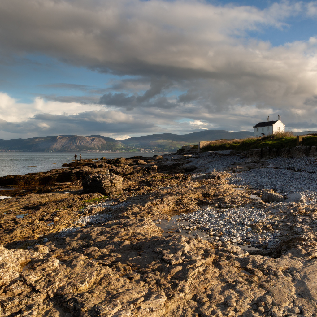 Низкие серые облака над каменным берегом у моря, Великобритания