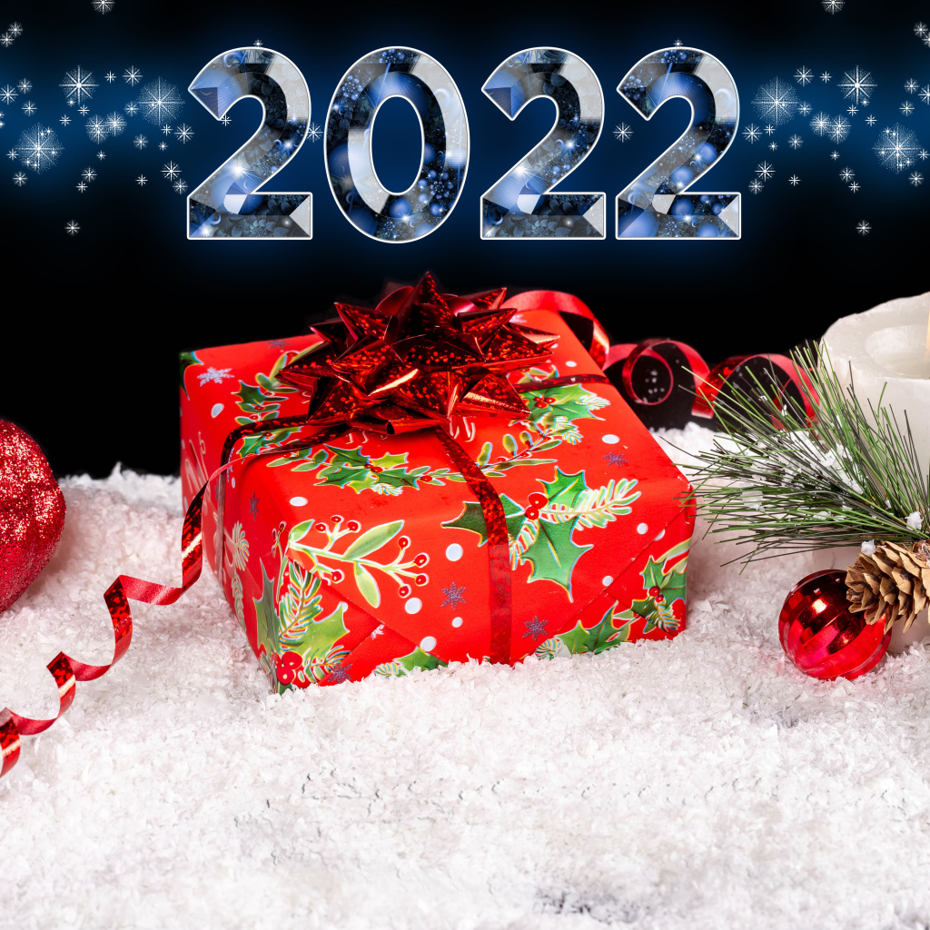 Подарок и свеча на снегу на новый год 2022 
