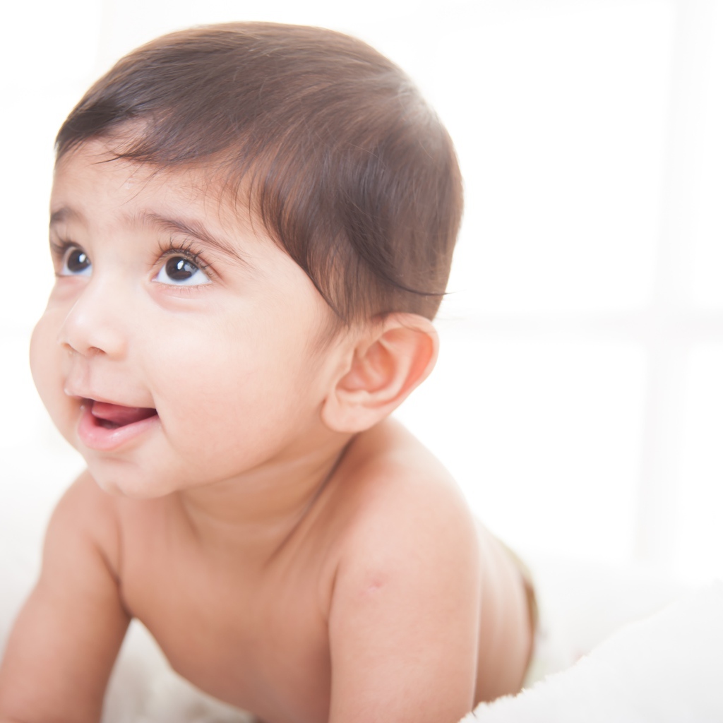 Маленький кареглазый мальчик на белом фоне 