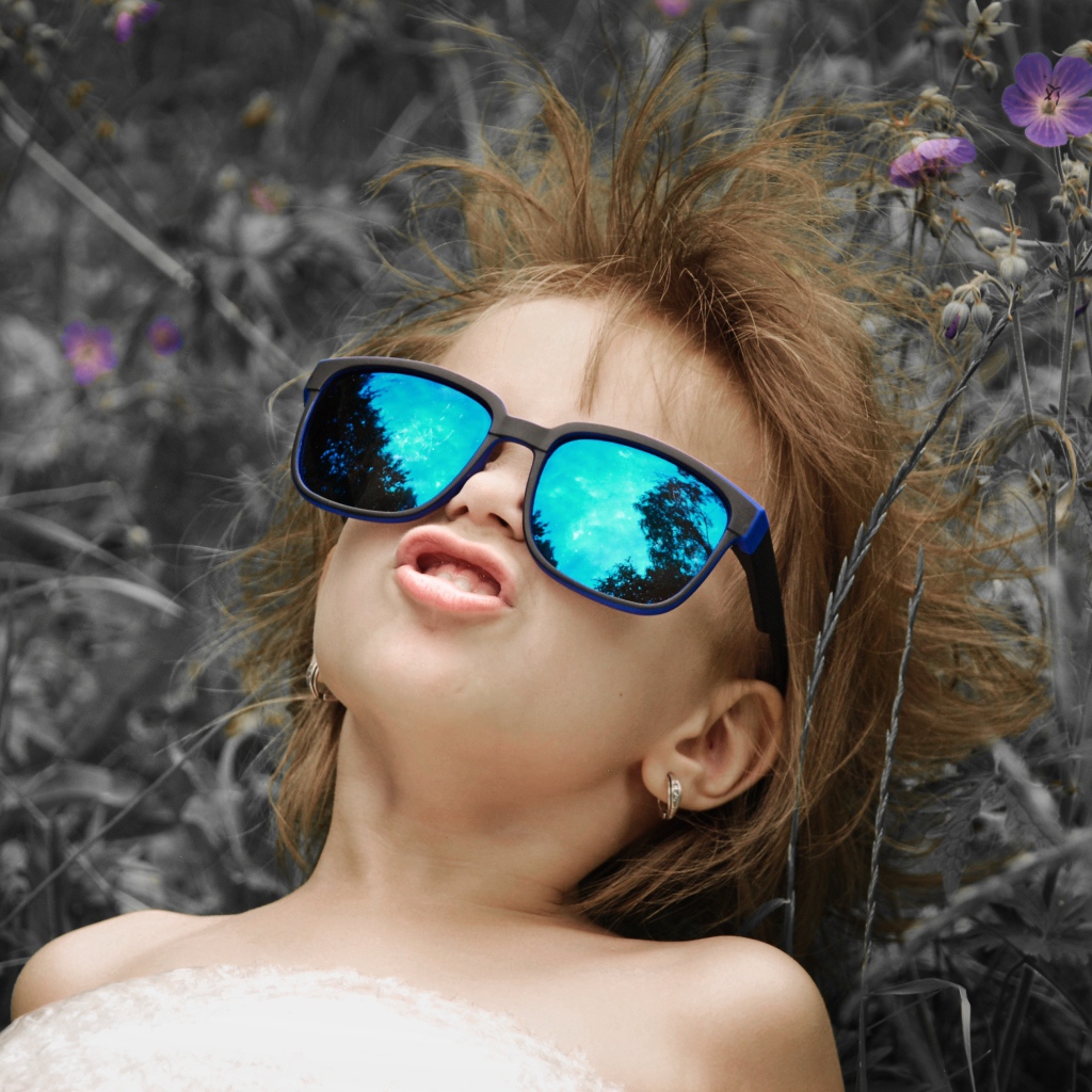 Маленькая девочка в очках со смешной прической