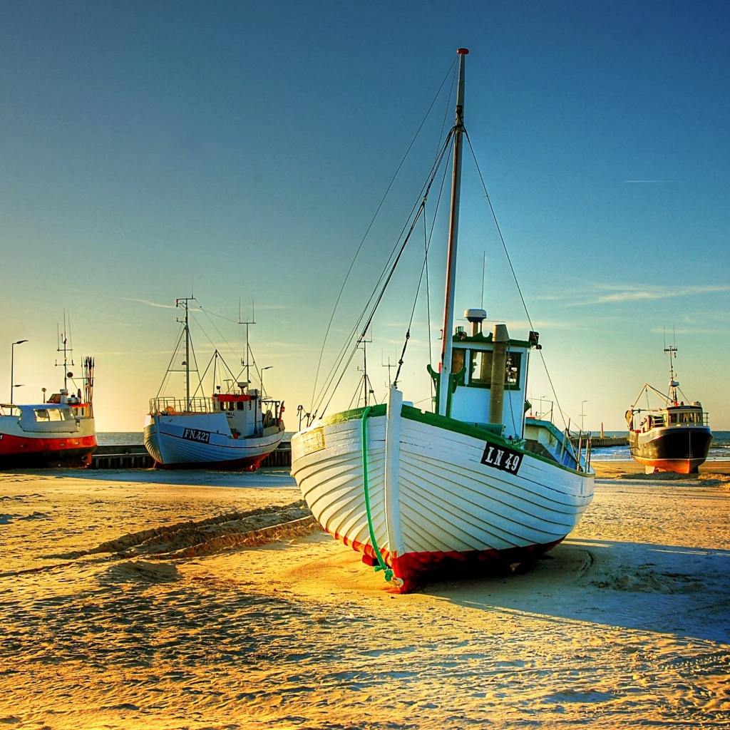 Fishing boats in the sun on the shore