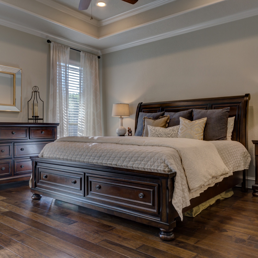 Большая деревянная кровать в спальной комнате 