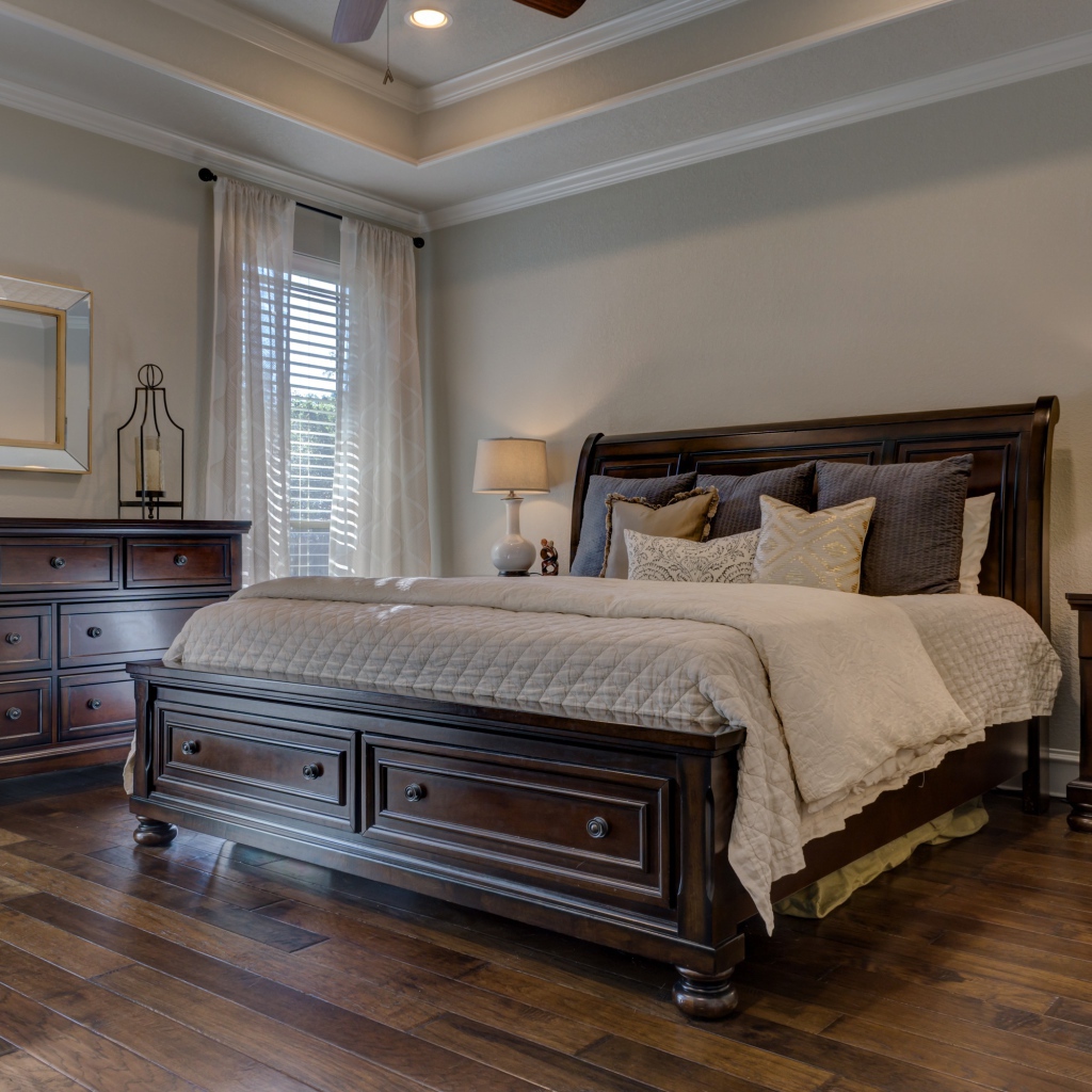 Большая деревянная кровать в спальной комнате 