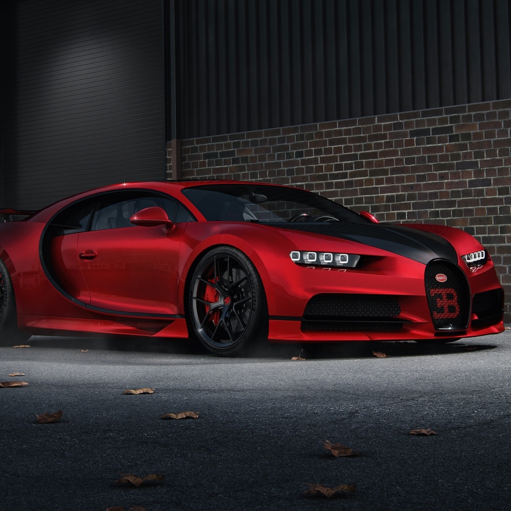 Красный автомобиль Bugatti Chiron CGI у кирпичной стены