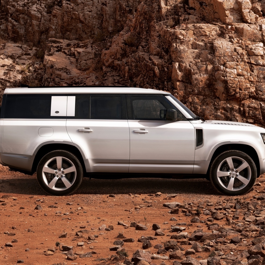 Белый внедорожник Land Rover Defender 130 в горах