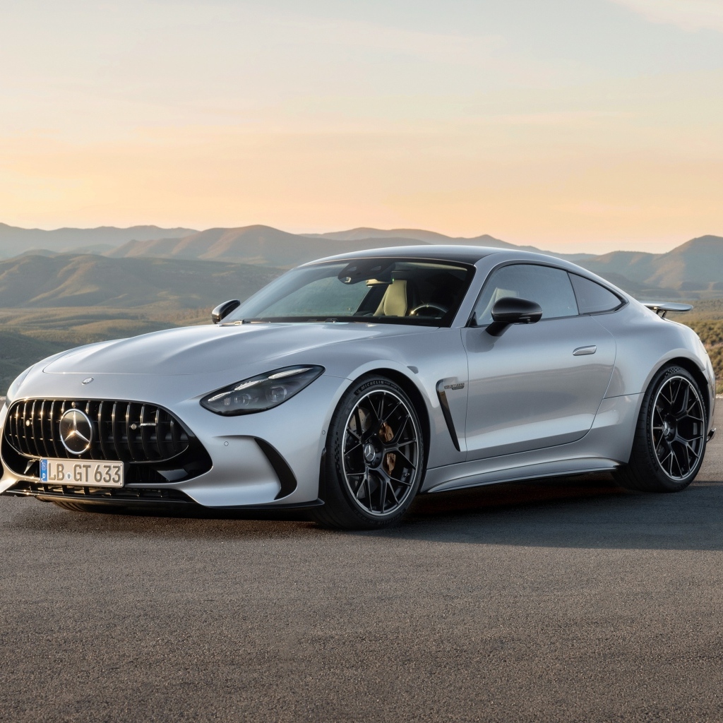 Серебристый автомобиль Mercedes-AMG GT 63 4MATIC+ 2023 года на фоне гор