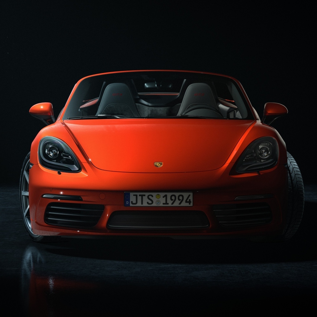 Красный автомобиль Porsche 911 CGI  вид спереди на черном фоне