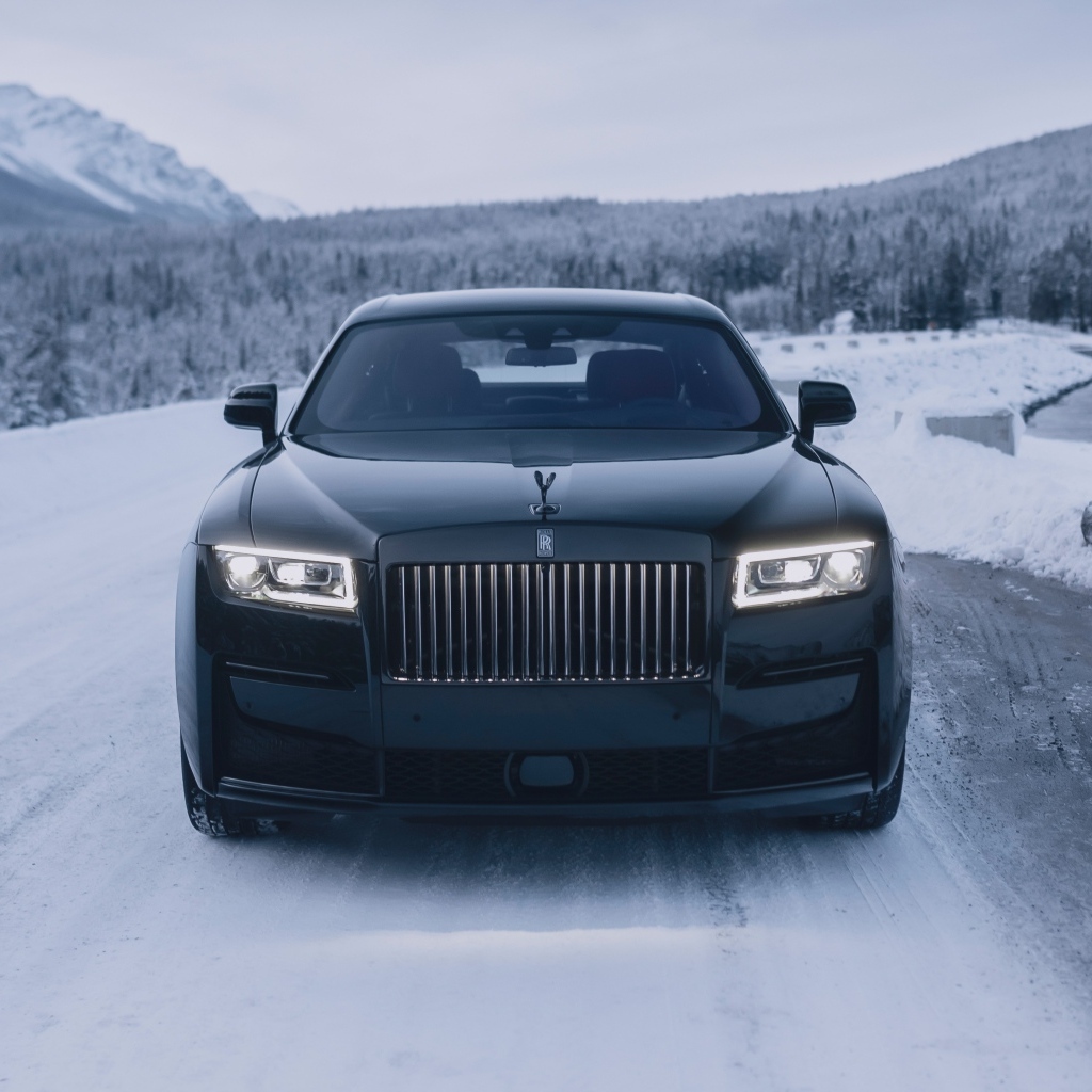 Черный автомобиль Rolls-Royce Black Badge Ghost  на зимней дороге