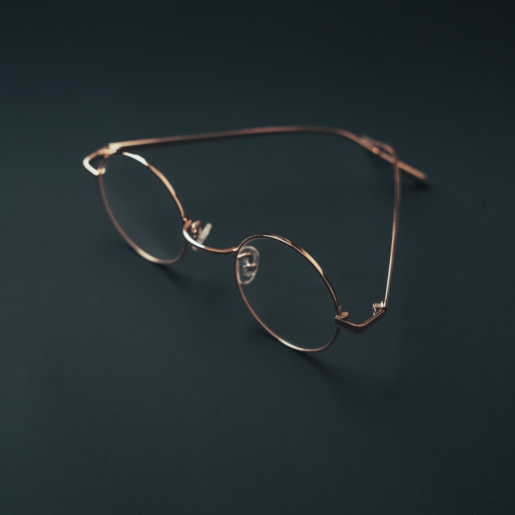 Очки лежат на серой поверхности