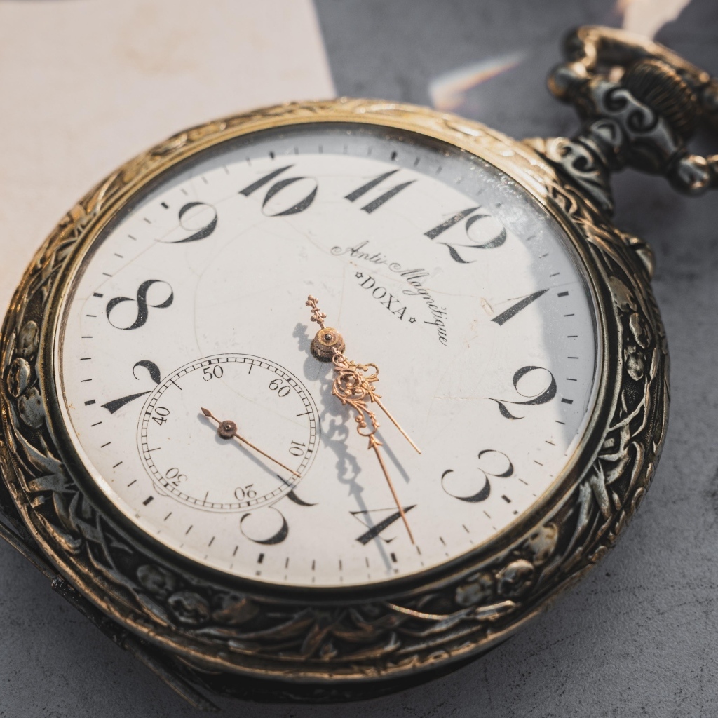 Старые карманные часы с золотыми стрелками