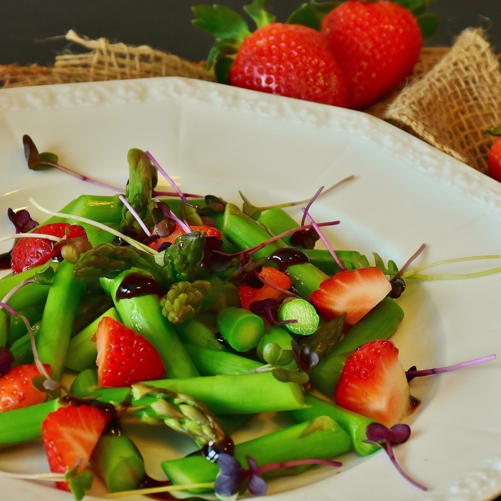 Спаржа в тарелке с клубникой