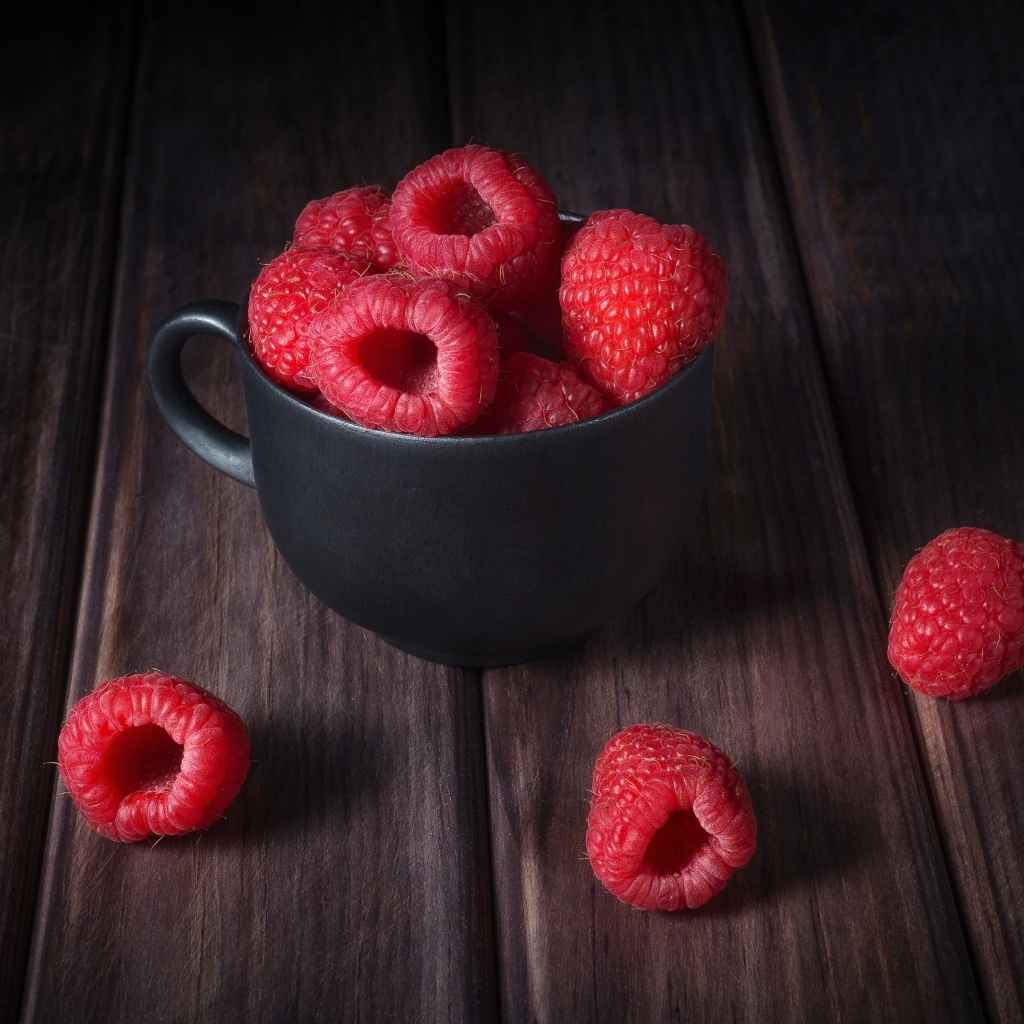Black cup with red raspberries