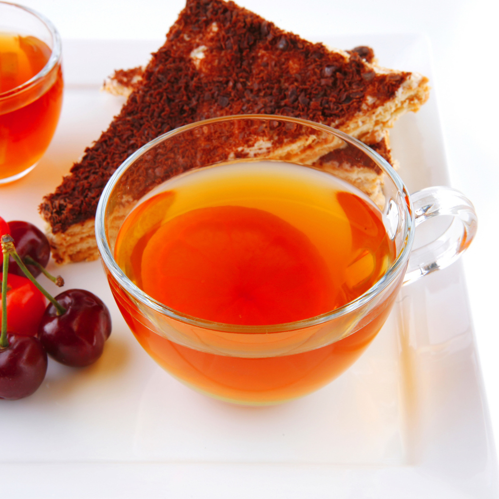 Чашка чая с тортом и ягодами черешни