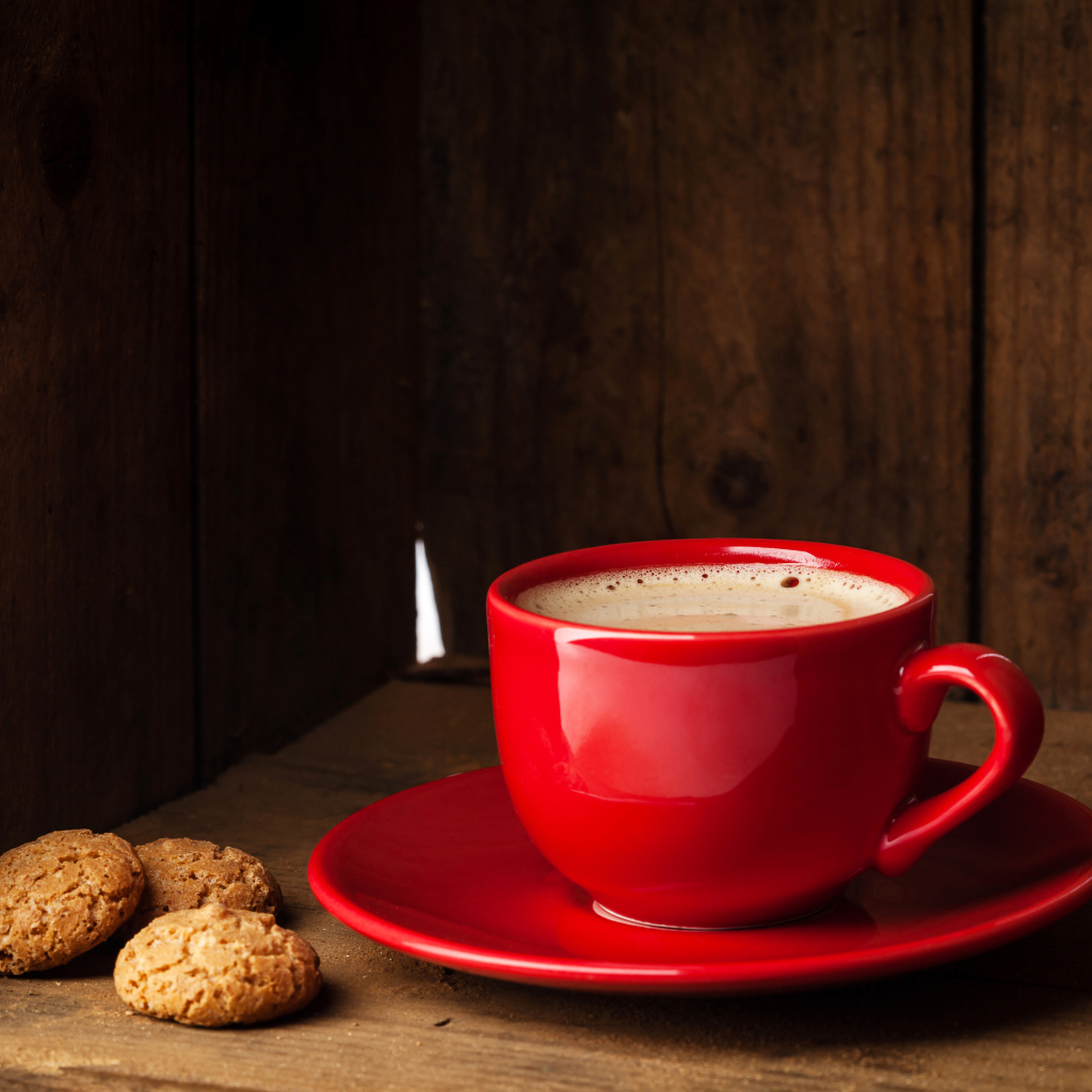Красная чашка кофе на столе с печеньем