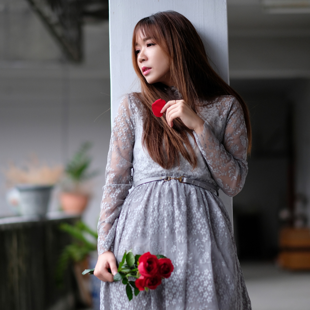 Asian girl in a gray dress with rose flowers