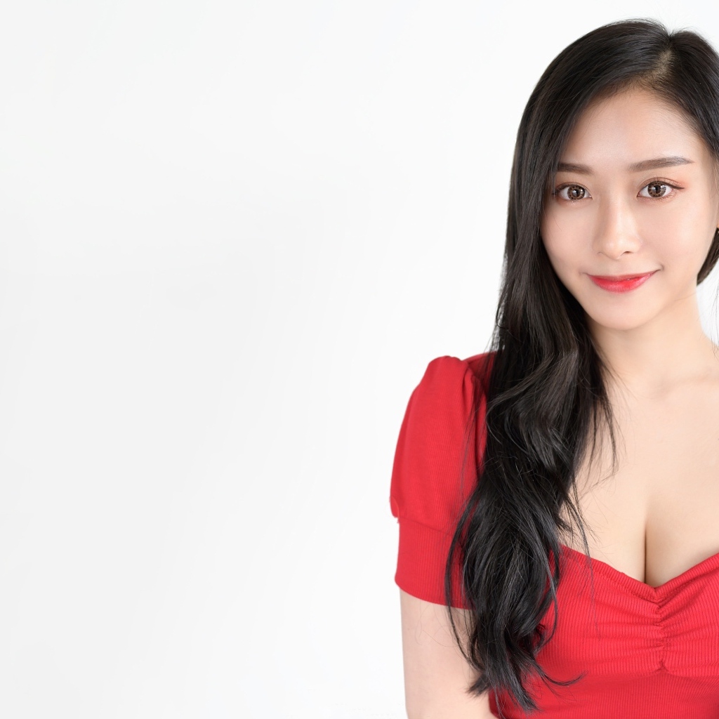 Девушка азиатка в красном платье на белом фоне