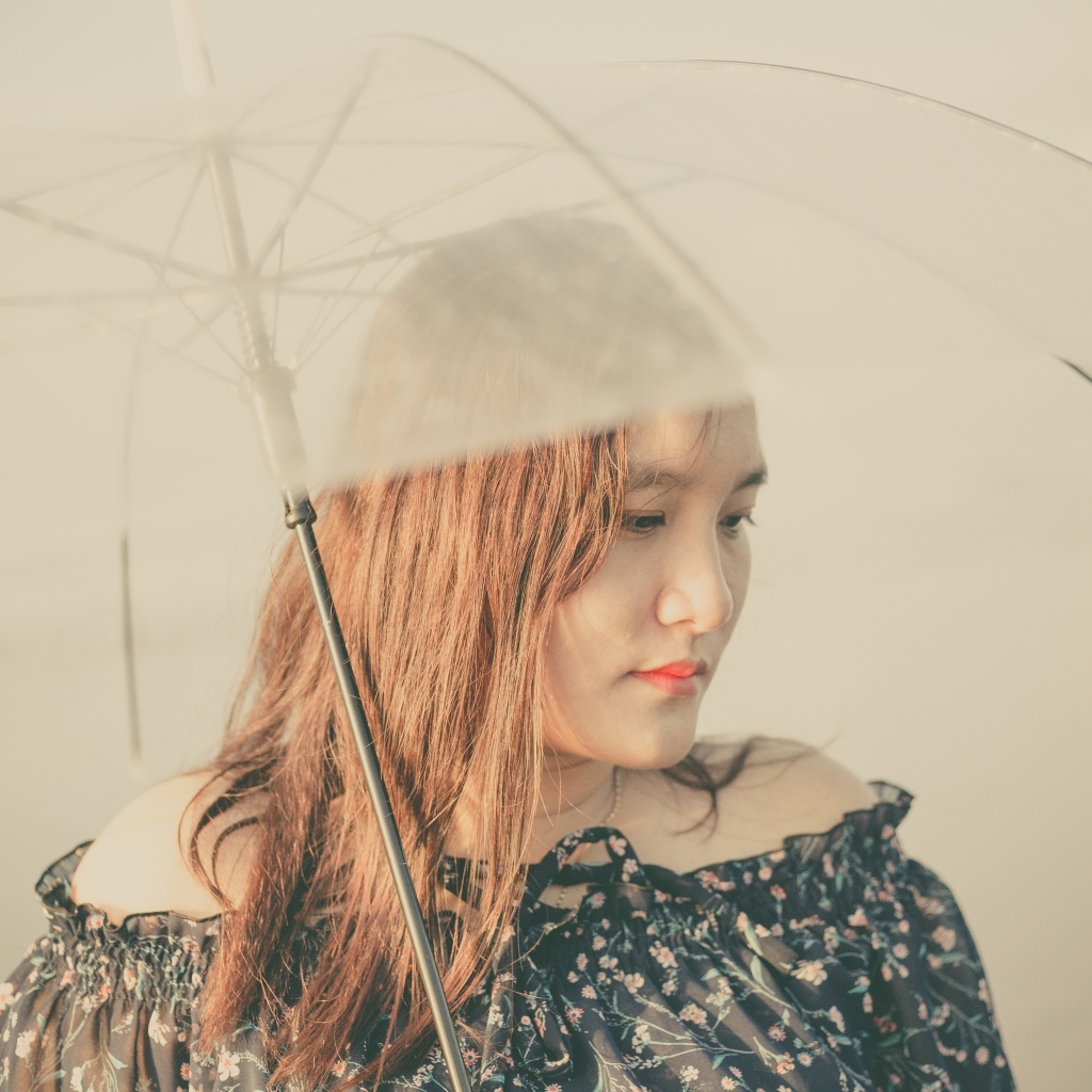 Девушка азиатка под прозрачным зонтом