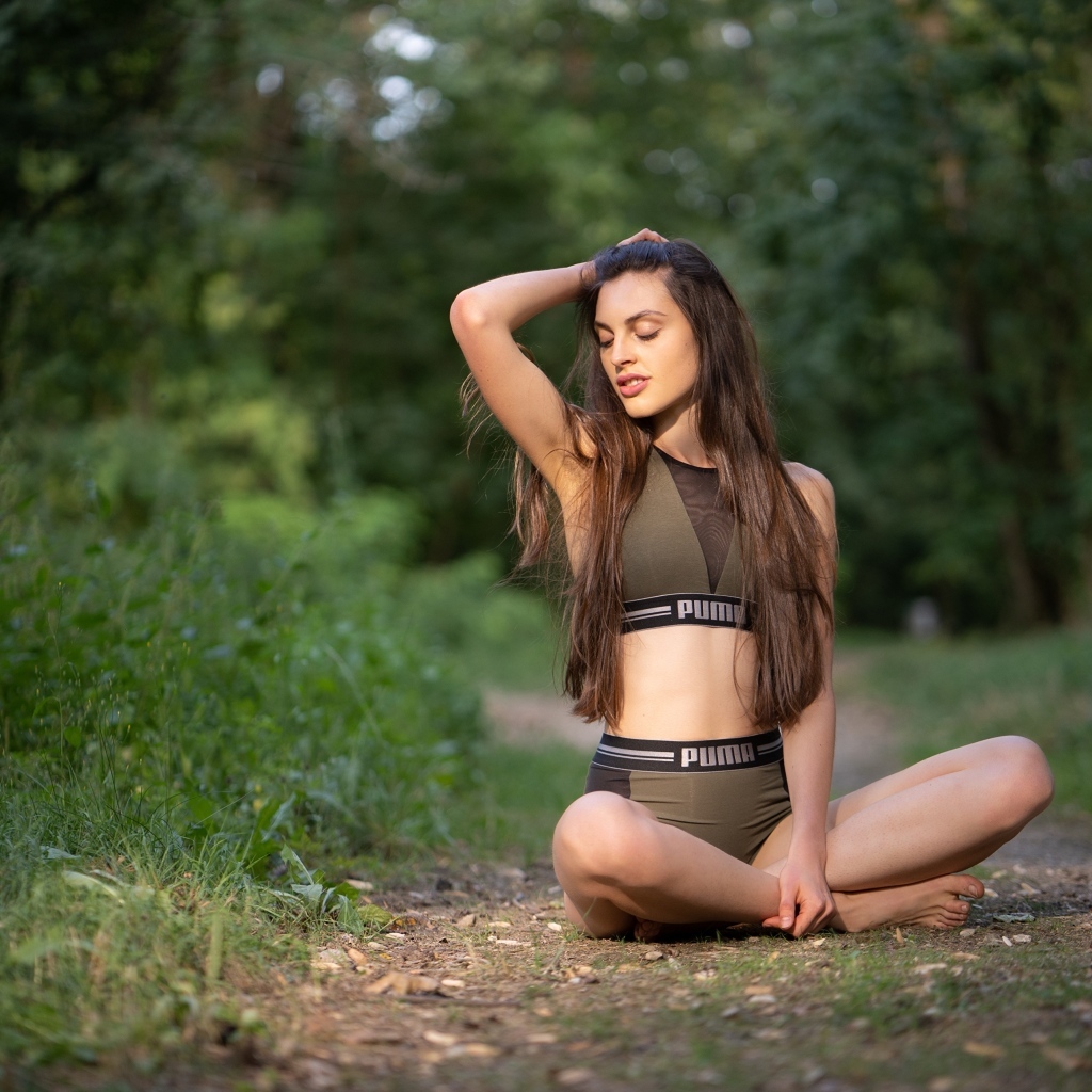 Девушка сидит в позе лотоса в осеннем парке