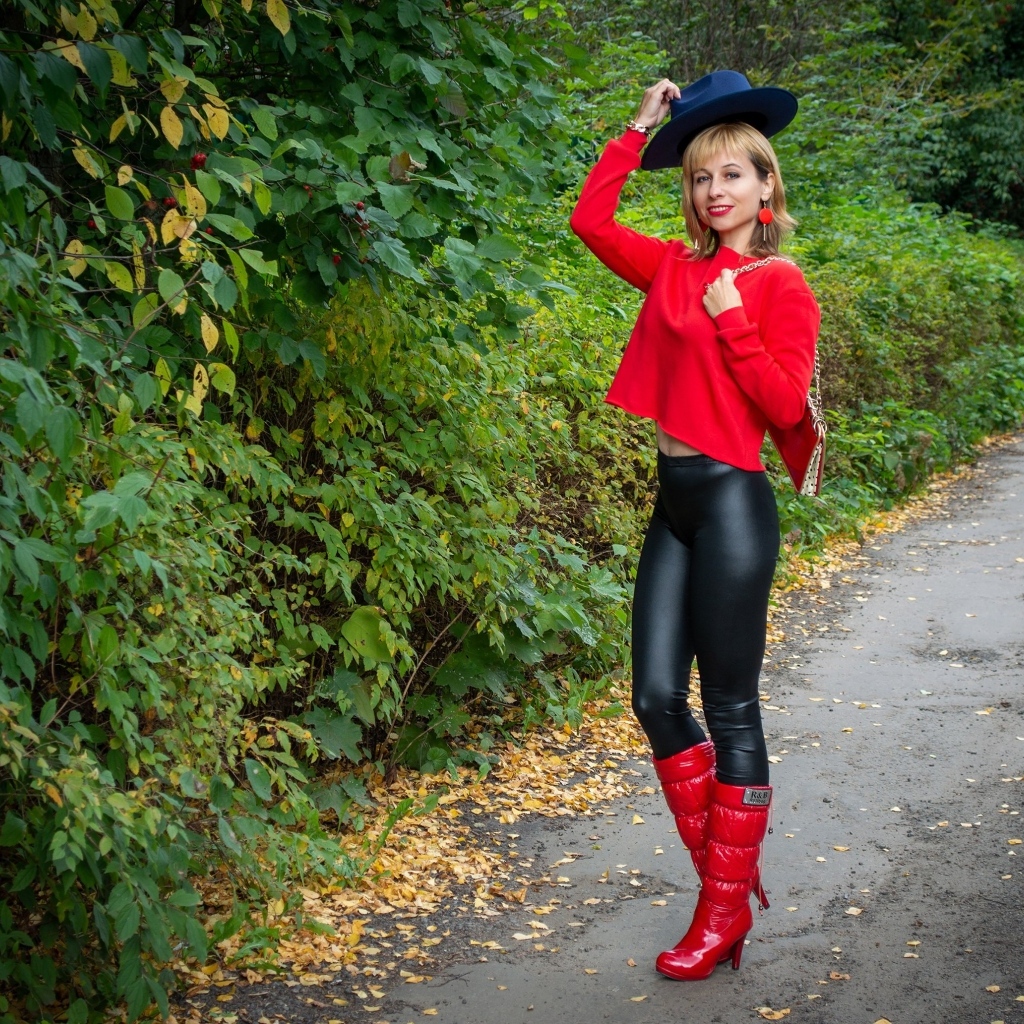 Молодая девушка в черно-красном наряде в парке