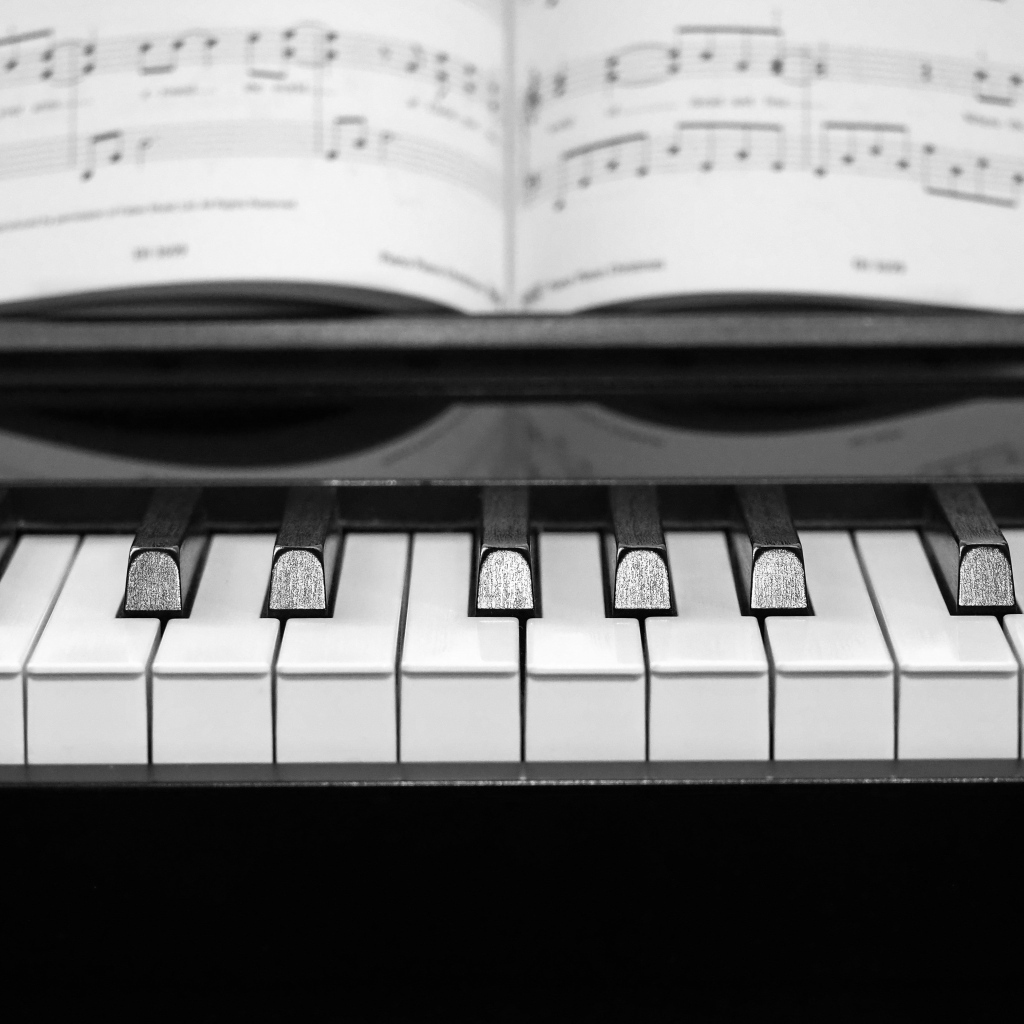 Клавиши пианино с нотной тетрадью