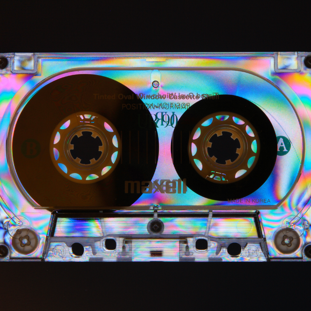Shiny cassette tape on black background