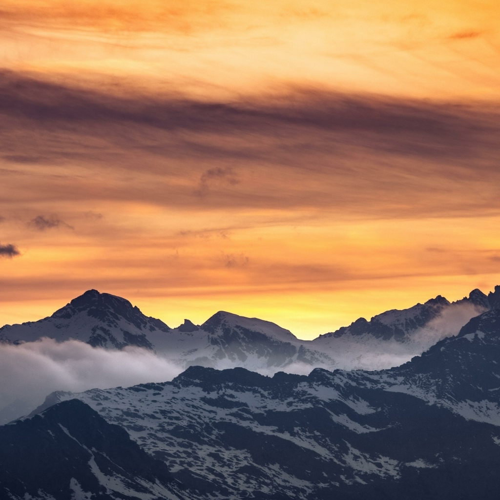 Красивый закат в небе над заснеженными горами