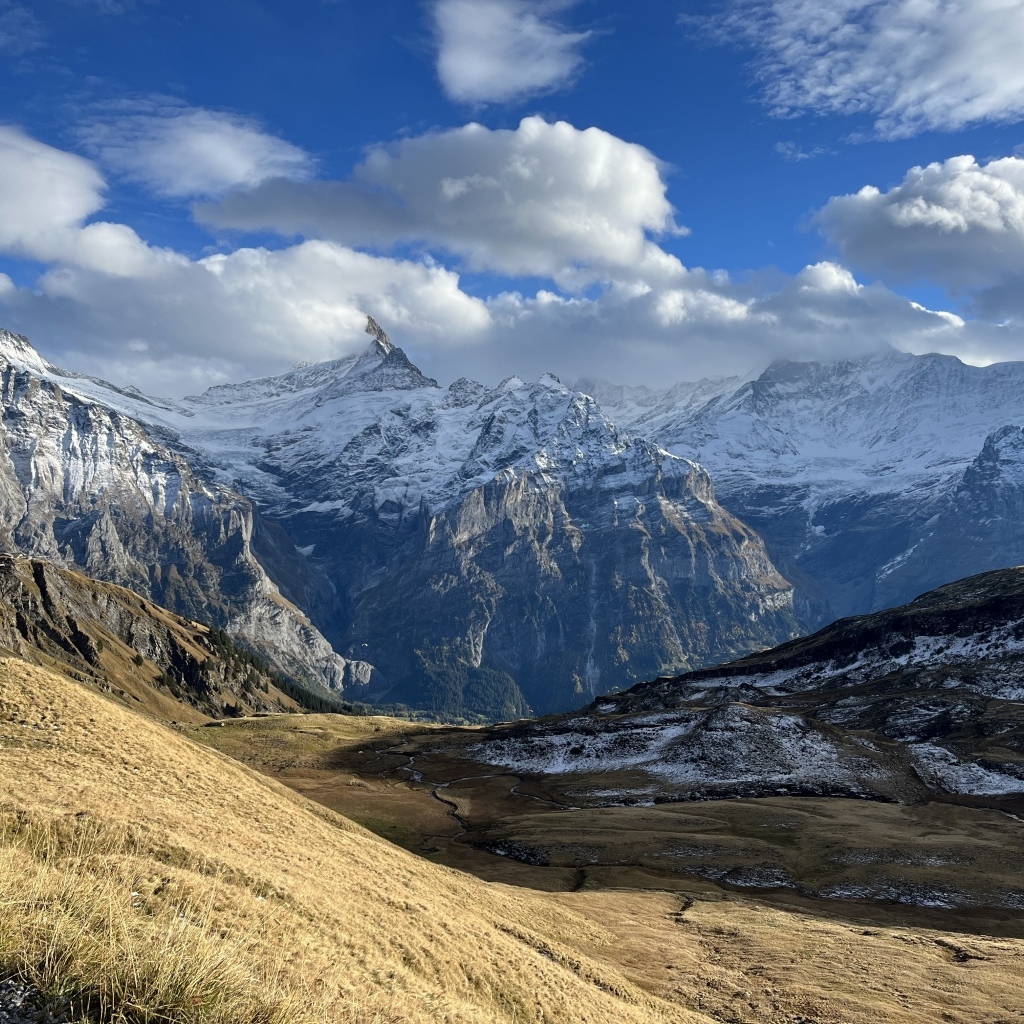 Высокие покрытые снегом горы в белых облаках