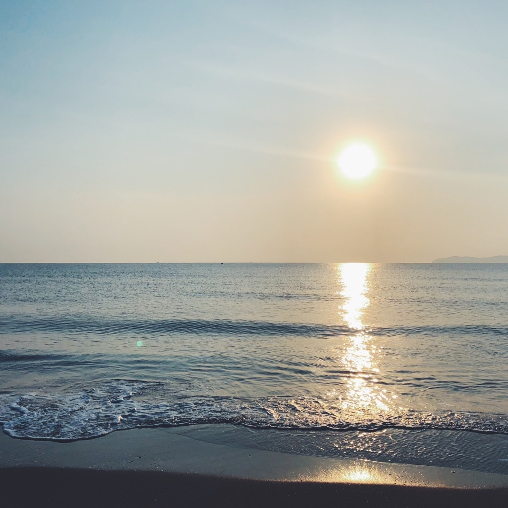 Яркое солнце над спокойным морем летом