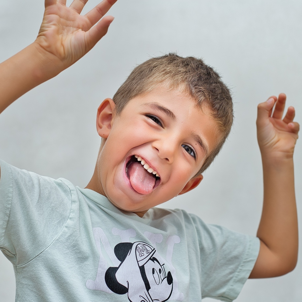 Смешной мальчик высунул язык