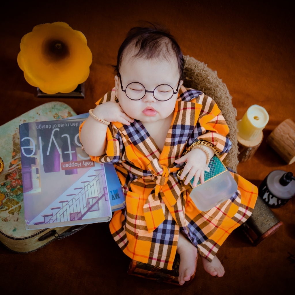 Маленький спящий ребенок в очках и халате