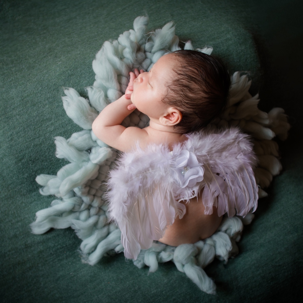 Спящий новорожденный малыш с крыльями ангела 