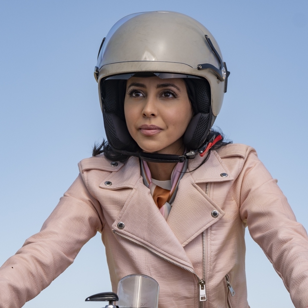 Актриса Джиа Сандху в шлеме на голубом фоне