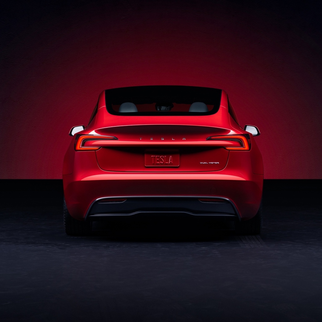 Красный автомобиль Tesla Model 3 2023 года вид сзади