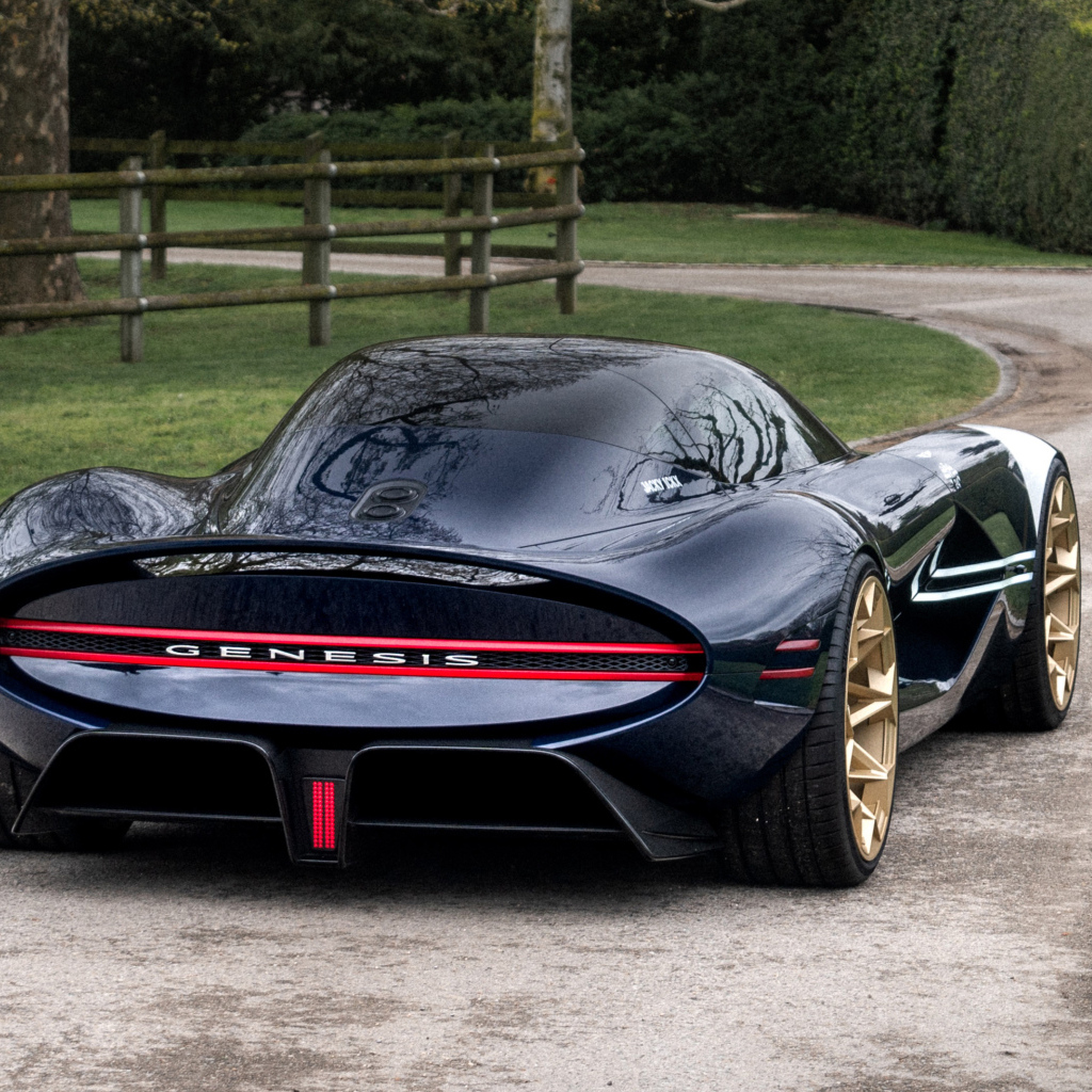 Вид сзади на черный дорогой автомобиль Genesis X Gran Berlinetta Tribute 2024  года