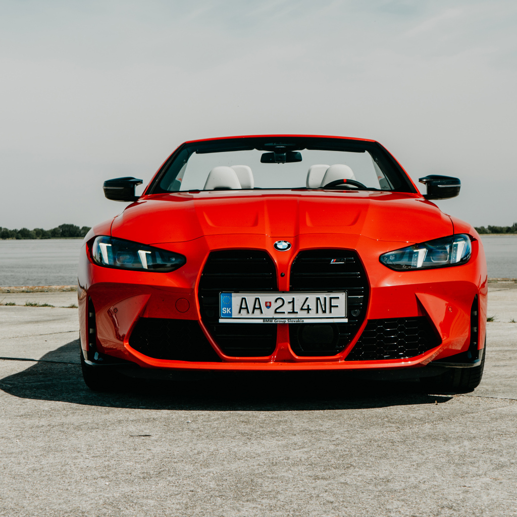 Вид спереди на красный автомобиль BMW M4 Competition M xDrive Cabrio 2024 года