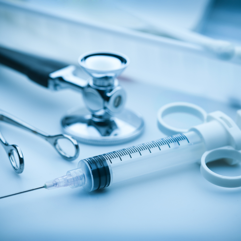 Шприц, зажим  и стетоскоп на столе