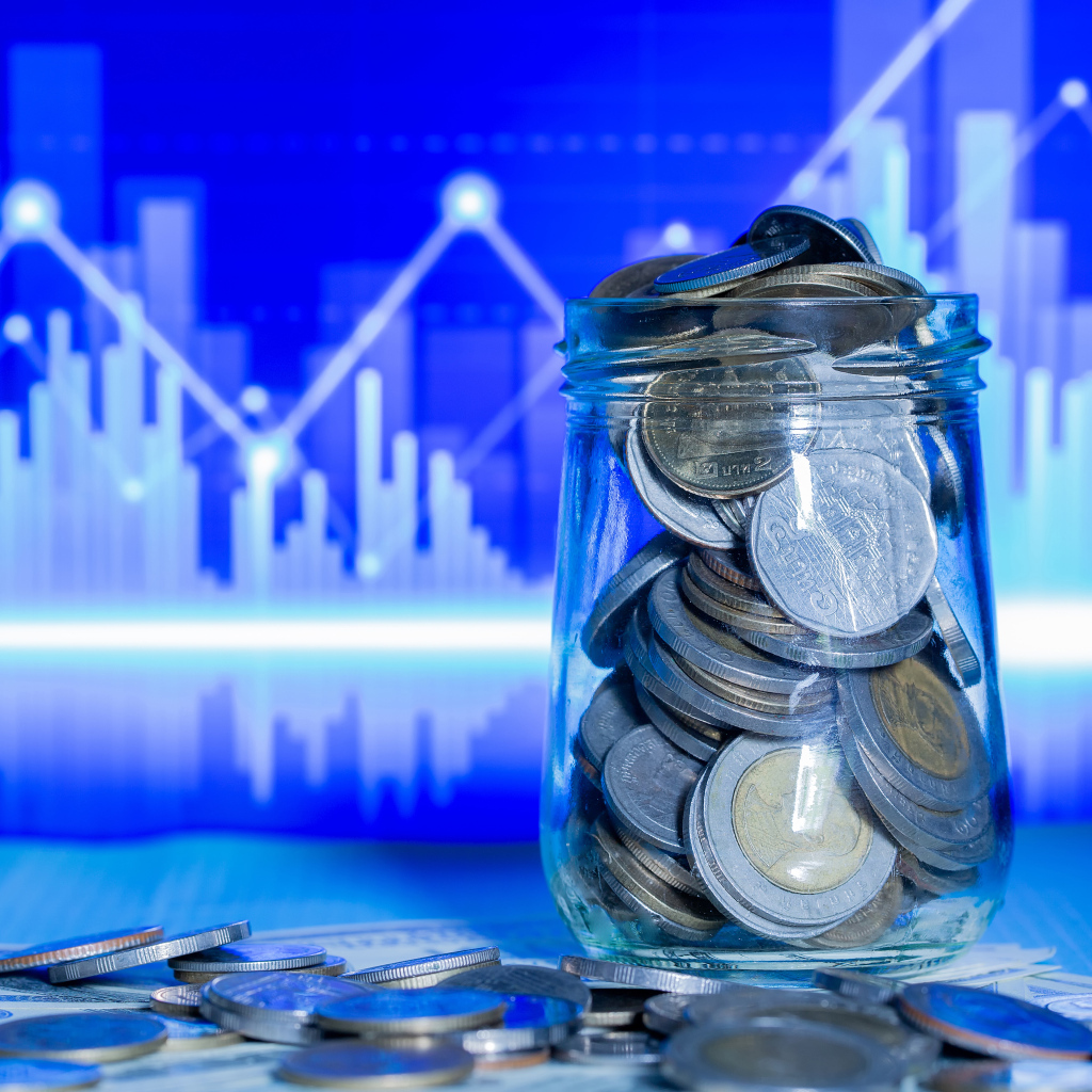 Банка с монетами на фоне таблицы