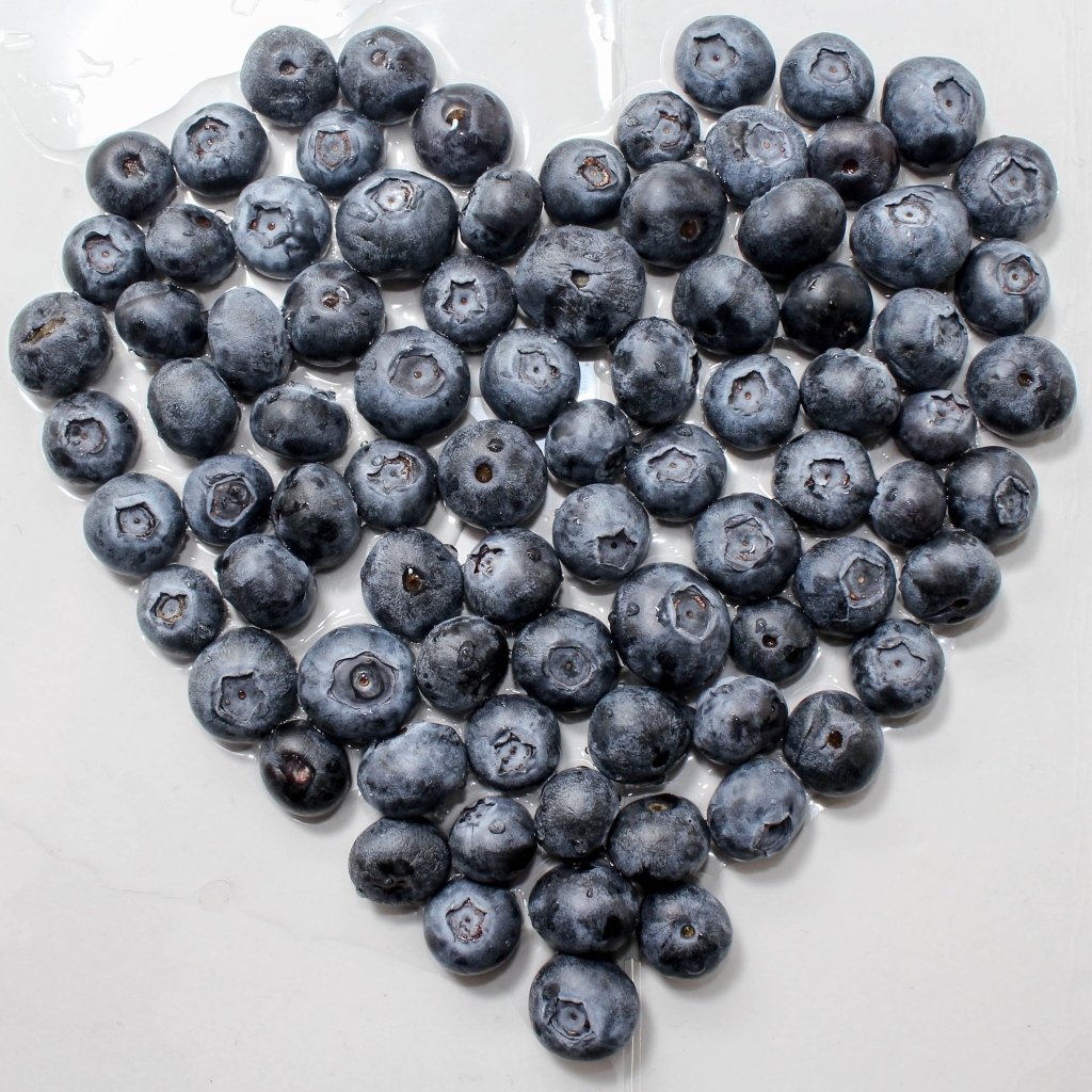 Сердце из ягод черники на сером столе