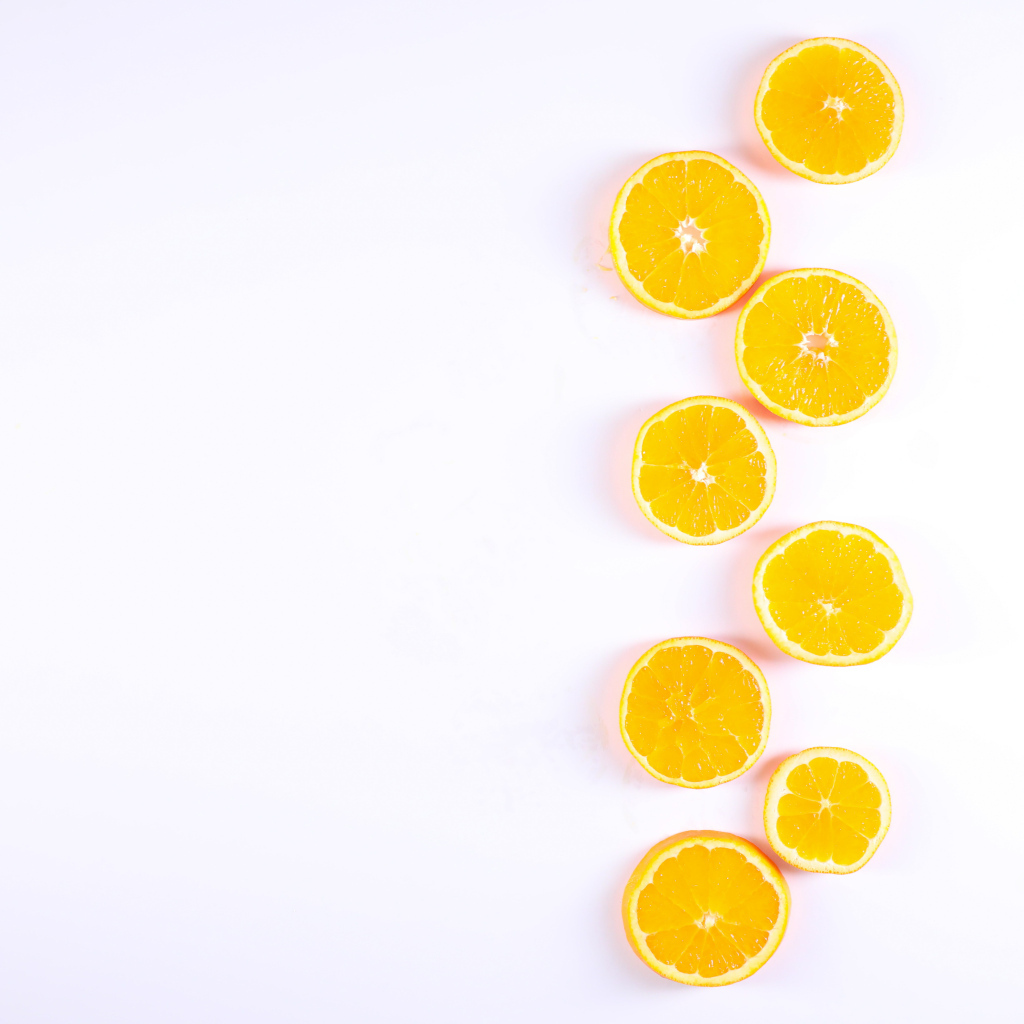 Много половинок лимона и апельсина на белом фоне